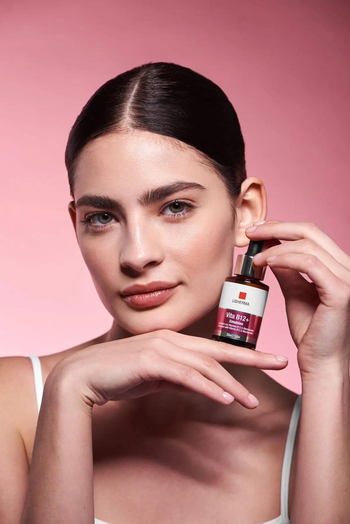 Woman holding beauty serum bottle